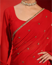 Ruby Red Embellished Saree by Agapi Clothing featuring sparkling handcrafted embellishments, a luxurious festive drape, and elegant Indian designer wear for weddings and receptions.
