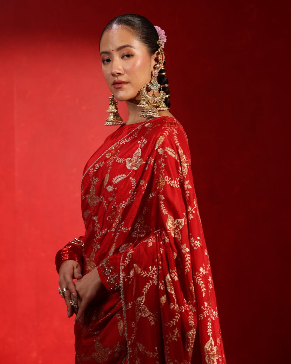 Suhaag Crimson Red Floral Saree by Agapi Clothing featuring elegant floral artistry, a graceful designer drape, and premium ethnic style for bridal and festive occasions.