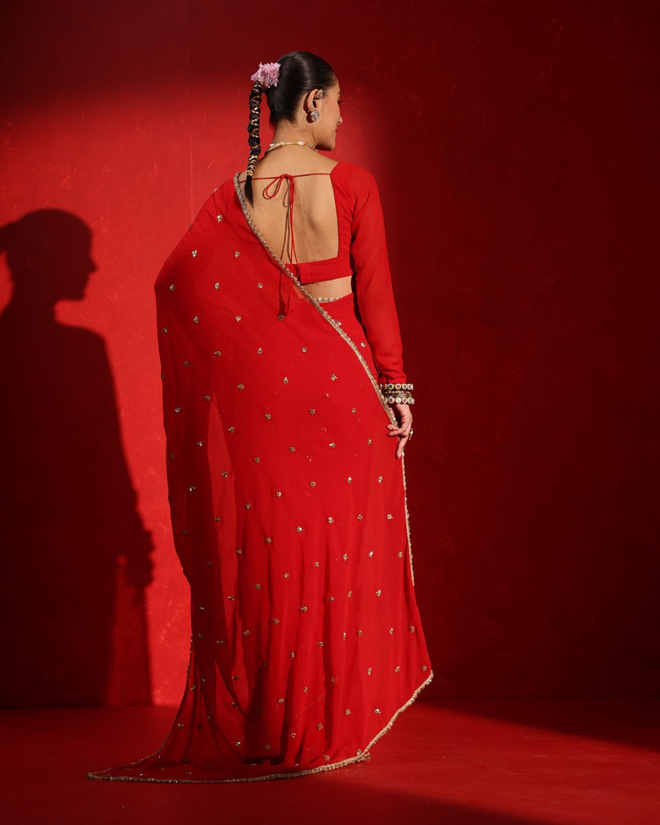 Ruby Red Embellished Saree by Agapi Clothing featuring sparkling handcrafted embellishments, a luxurious festive drape, and elegant Indian designer wear for weddings and receptions.