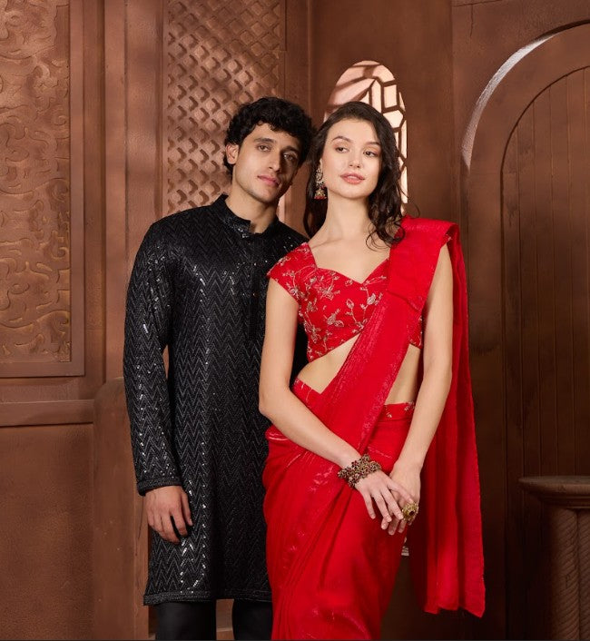 Man and woman in formal attire best standing rang collections against a wooden background