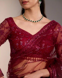 Women’s burgundy festive saree with elegant drape