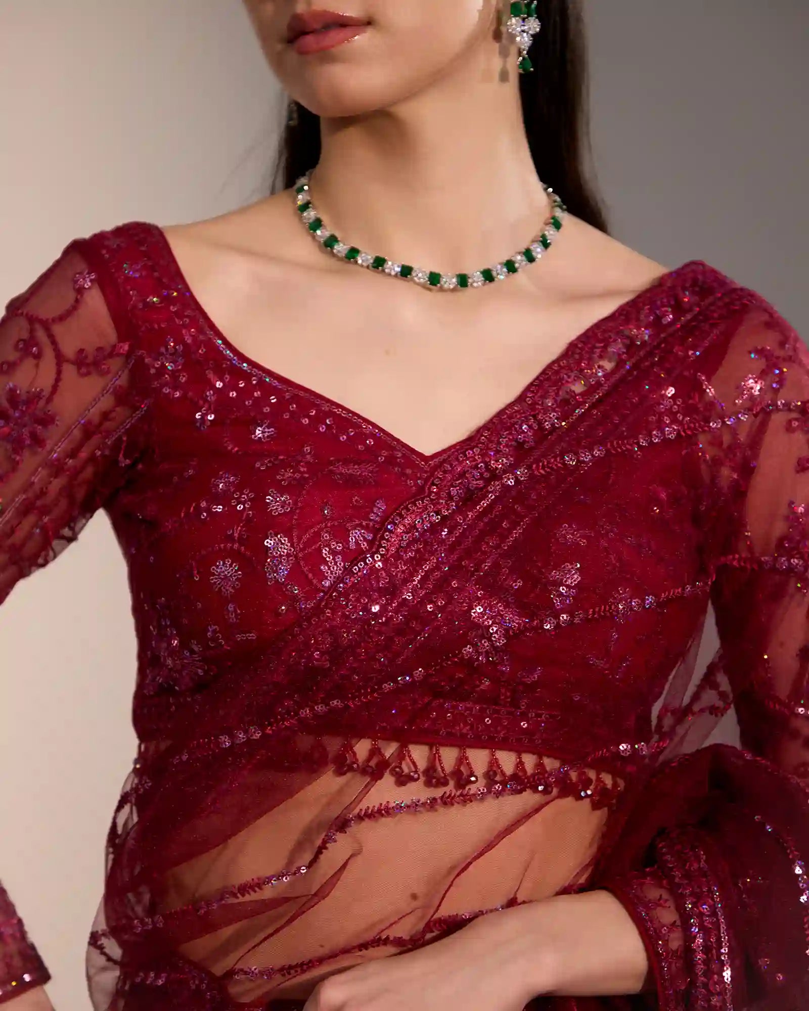 Women’s burgundy festive saree with elegant drape